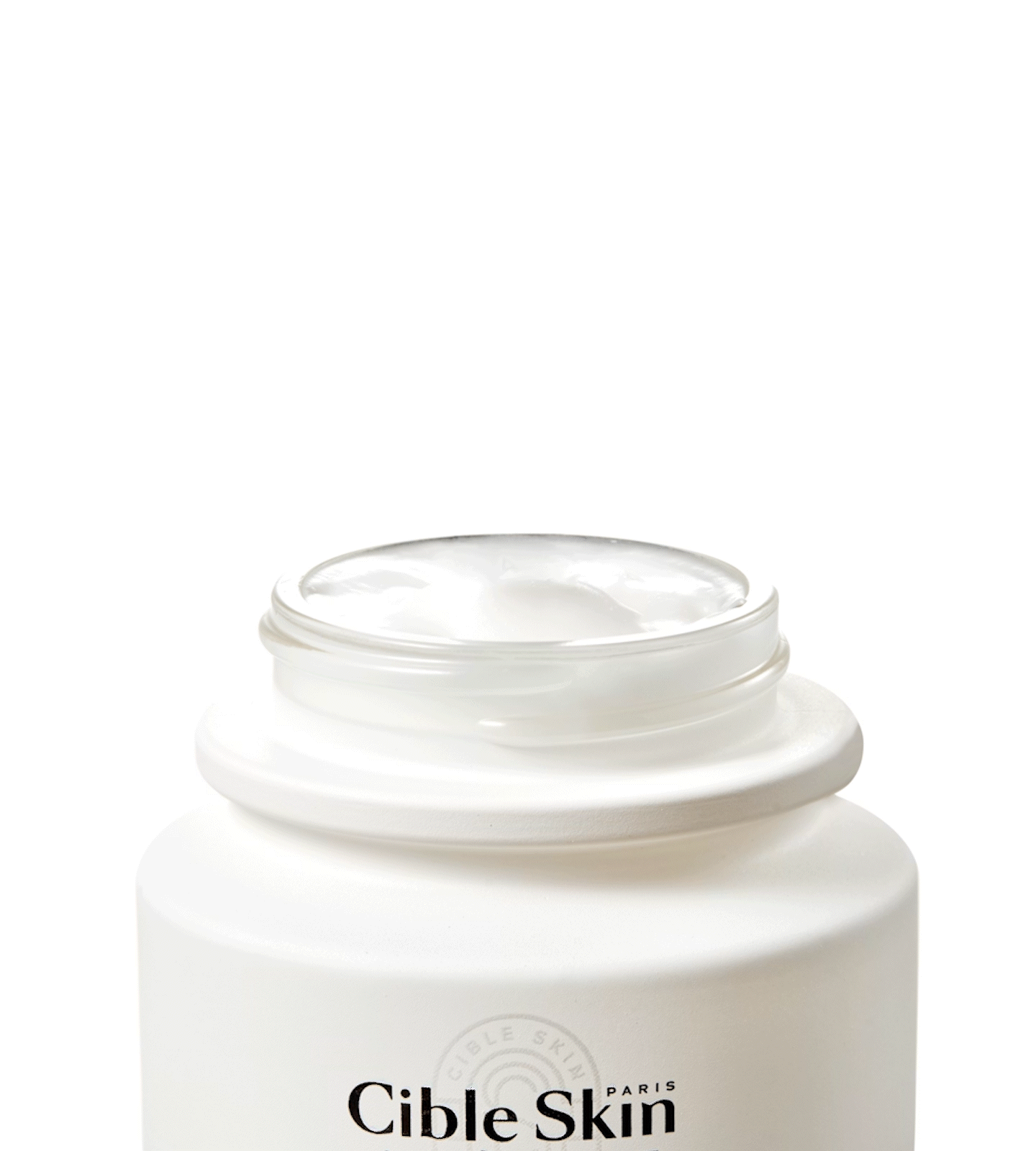 Open jar of Cible Skin Mask-Crème Culte with applicator-in-action